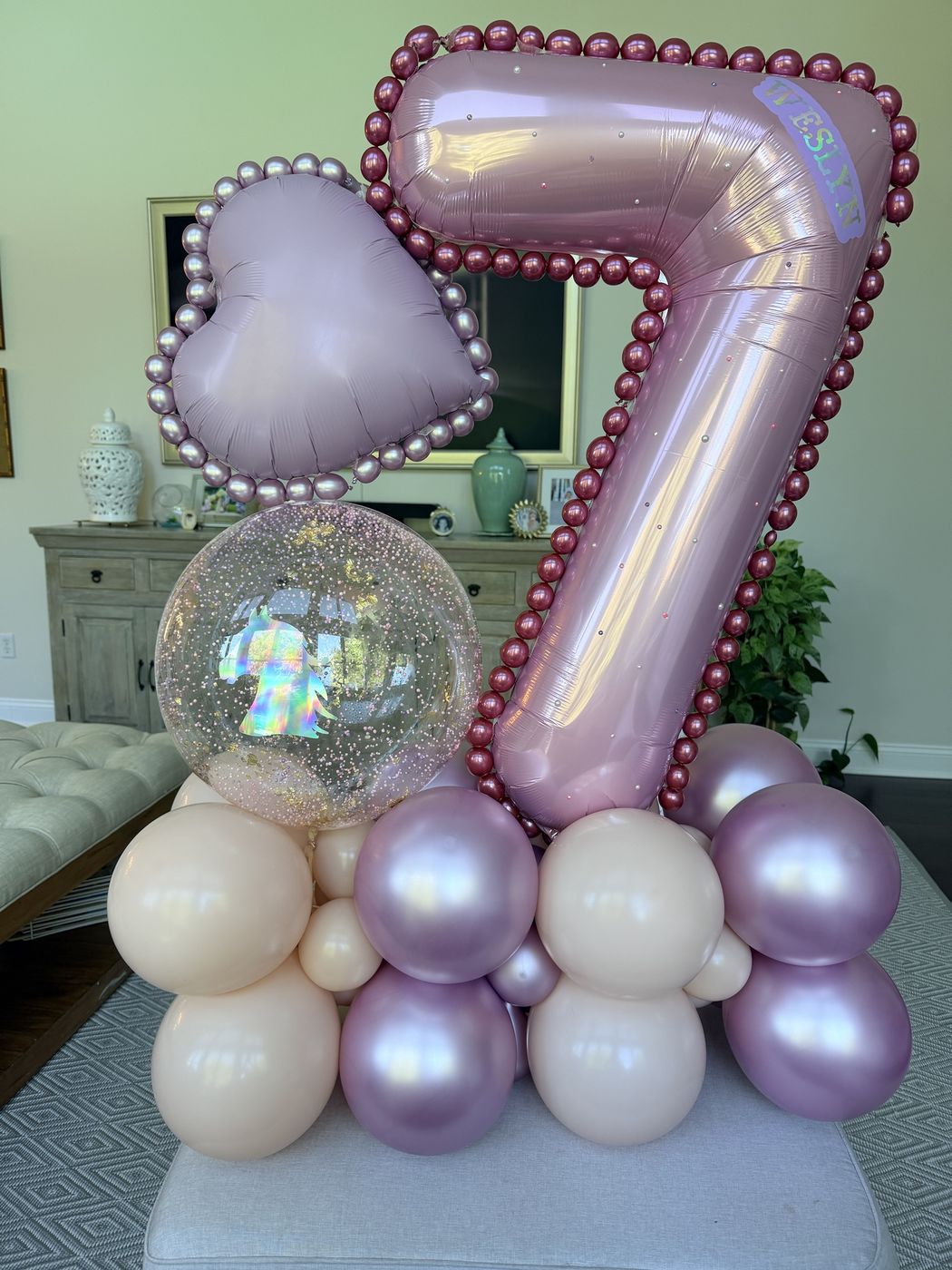 Pink metallic number seven balloon with pearl outline, heart foil and a glitter bubble balloon on a base